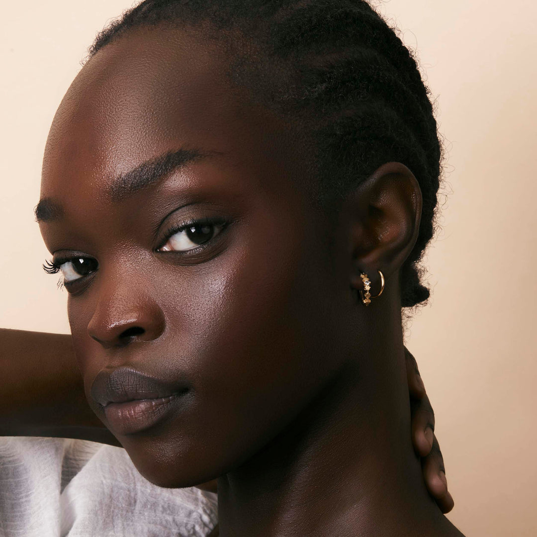 Night Glow Blue Topaz Huggies Gold